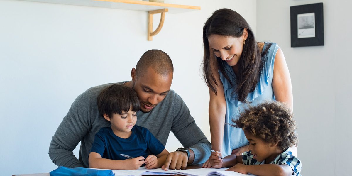 Parents helping their kids with a written activity