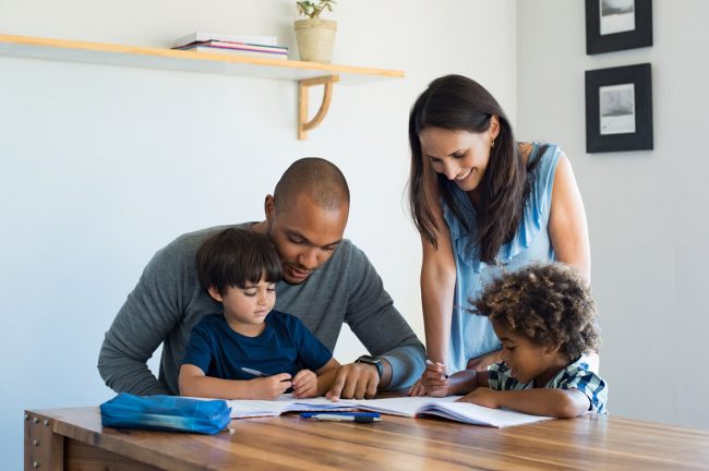 Parents helping their kids with a written activity